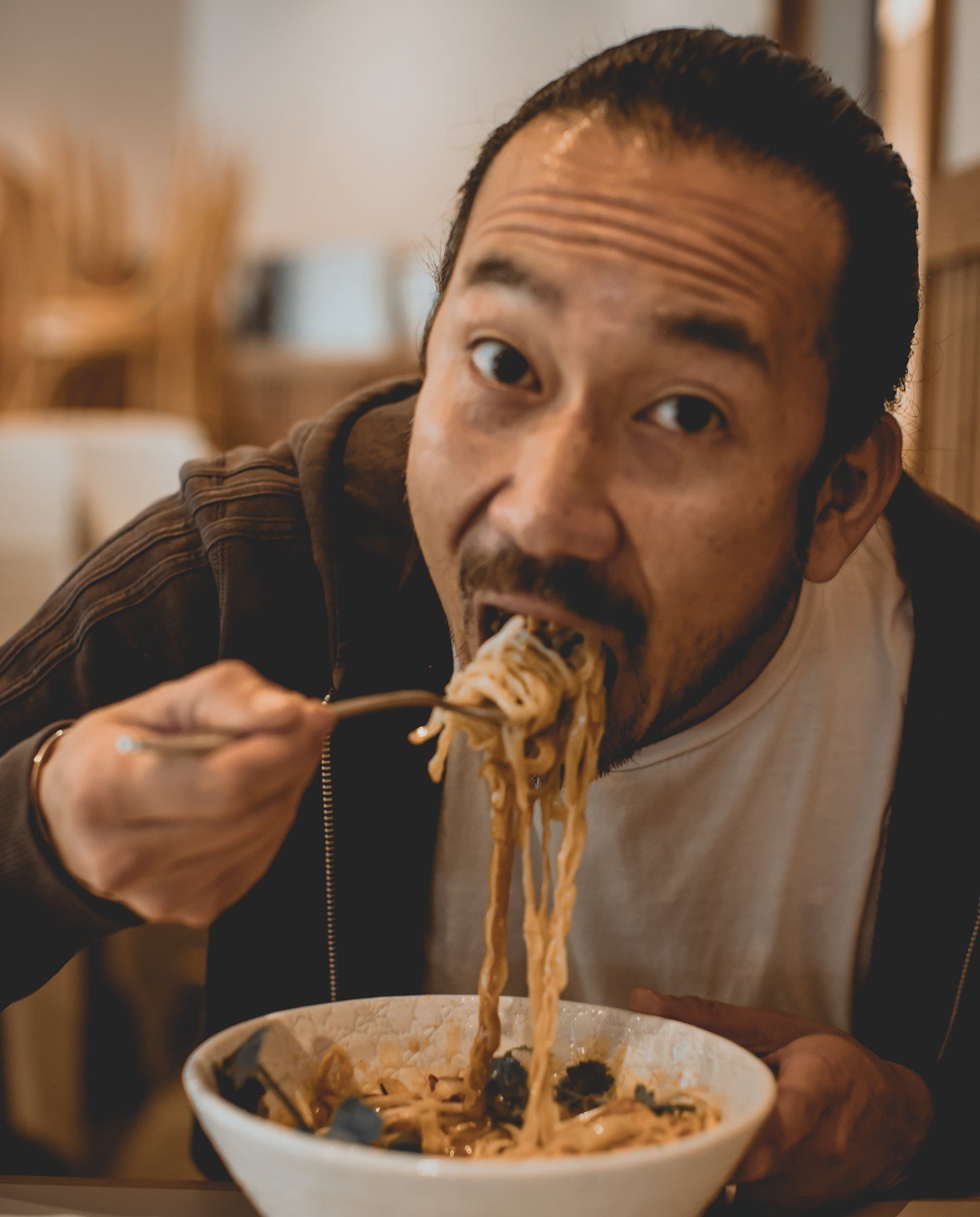 Someone digging into a bowl of noodles