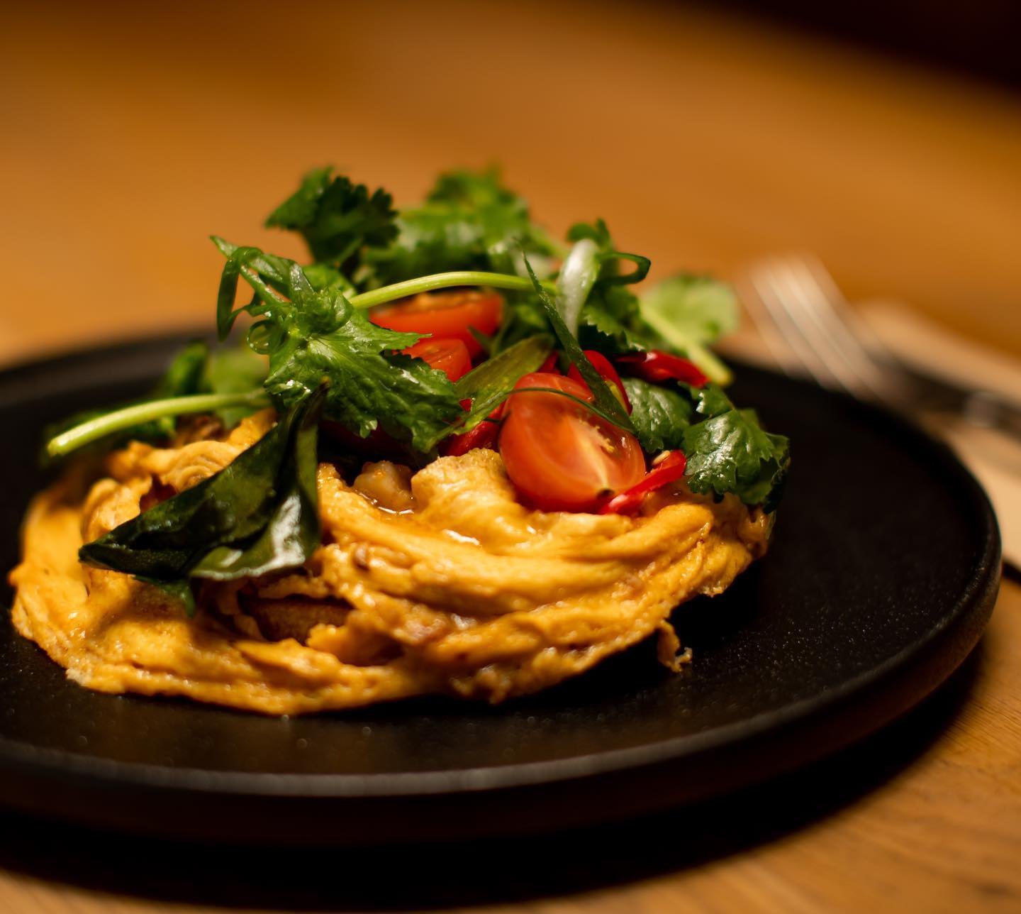 Sweet potato and carrot fritters under a fresh herb salad