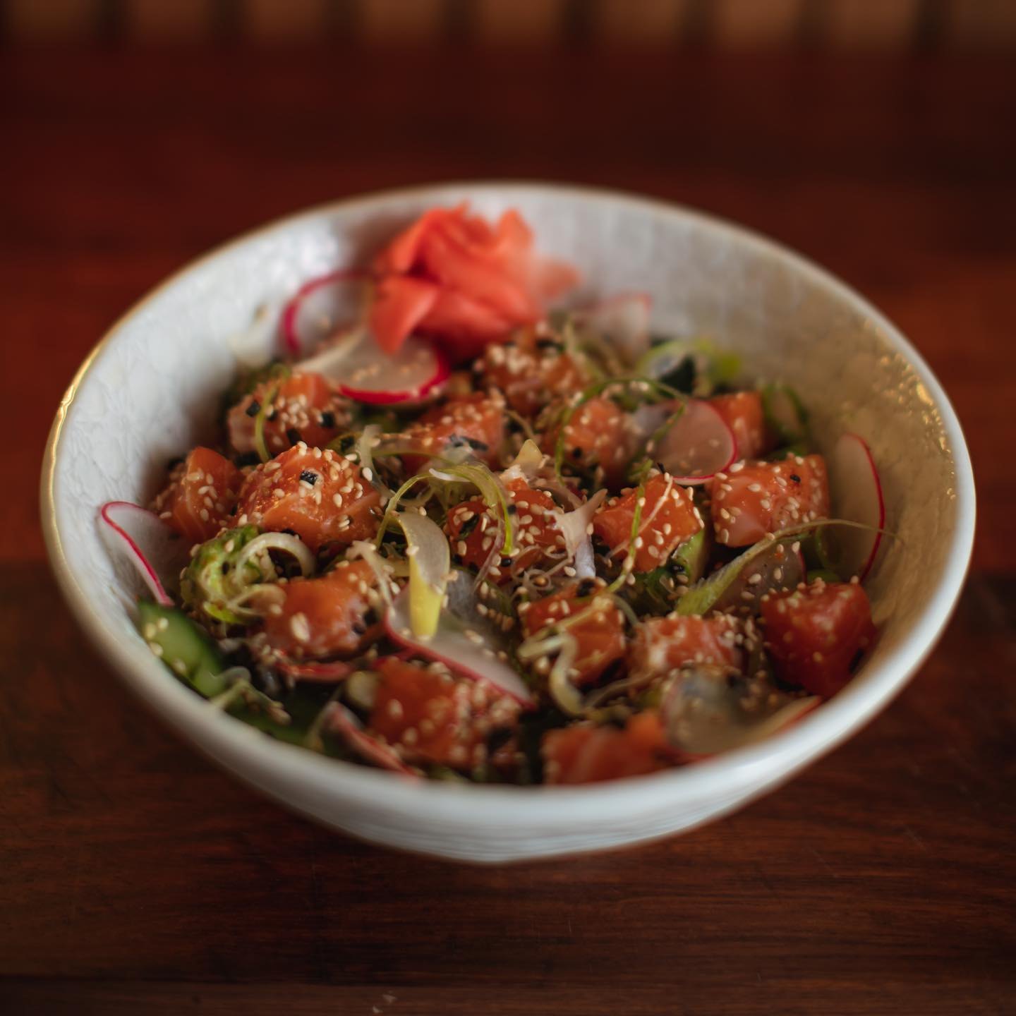 Poke don with marinated salmon, pickled ginger and sesame
